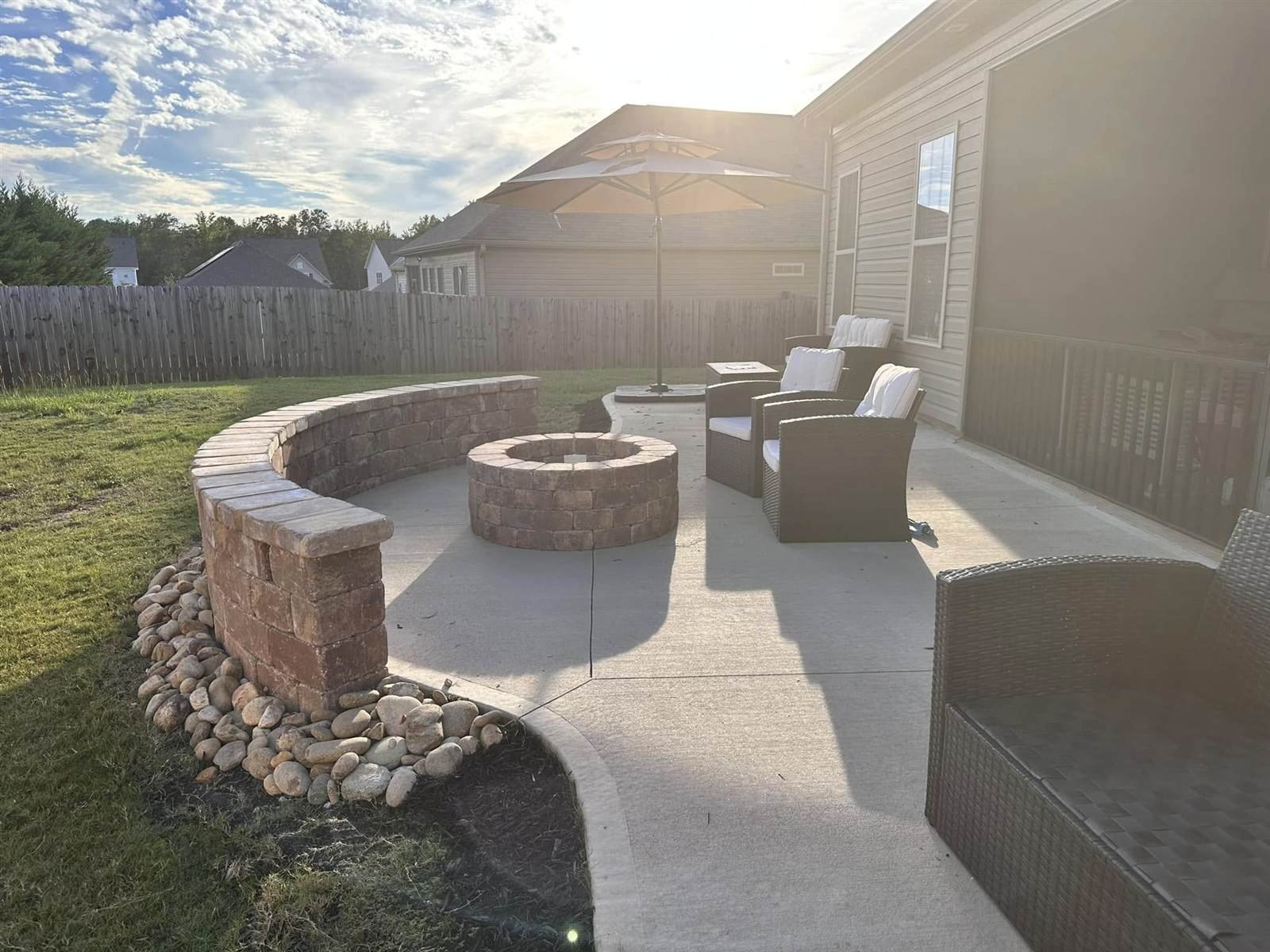 Curved seat wall and stone fire pit patio