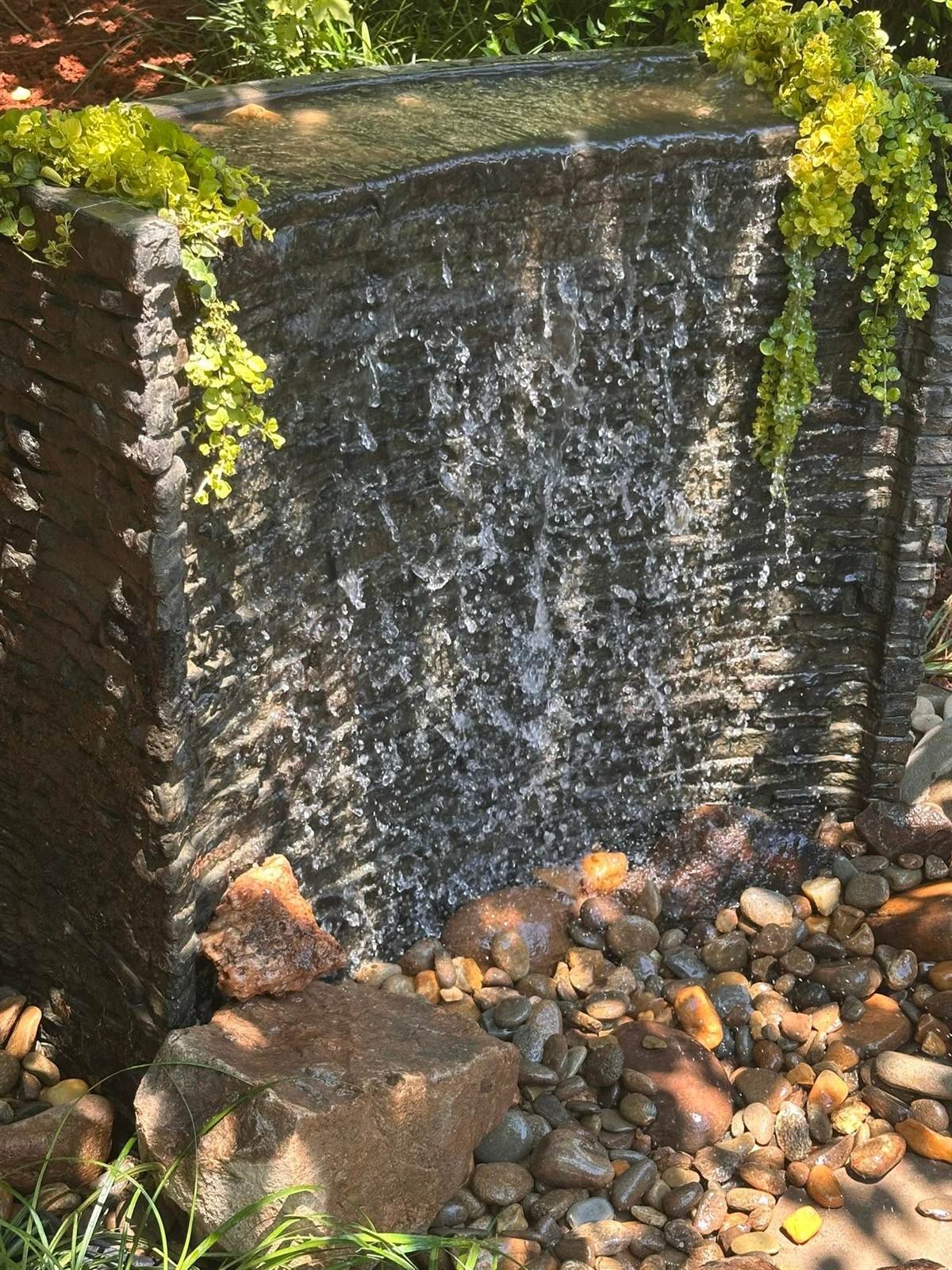 Modern stacked-stone waterfall wall feature