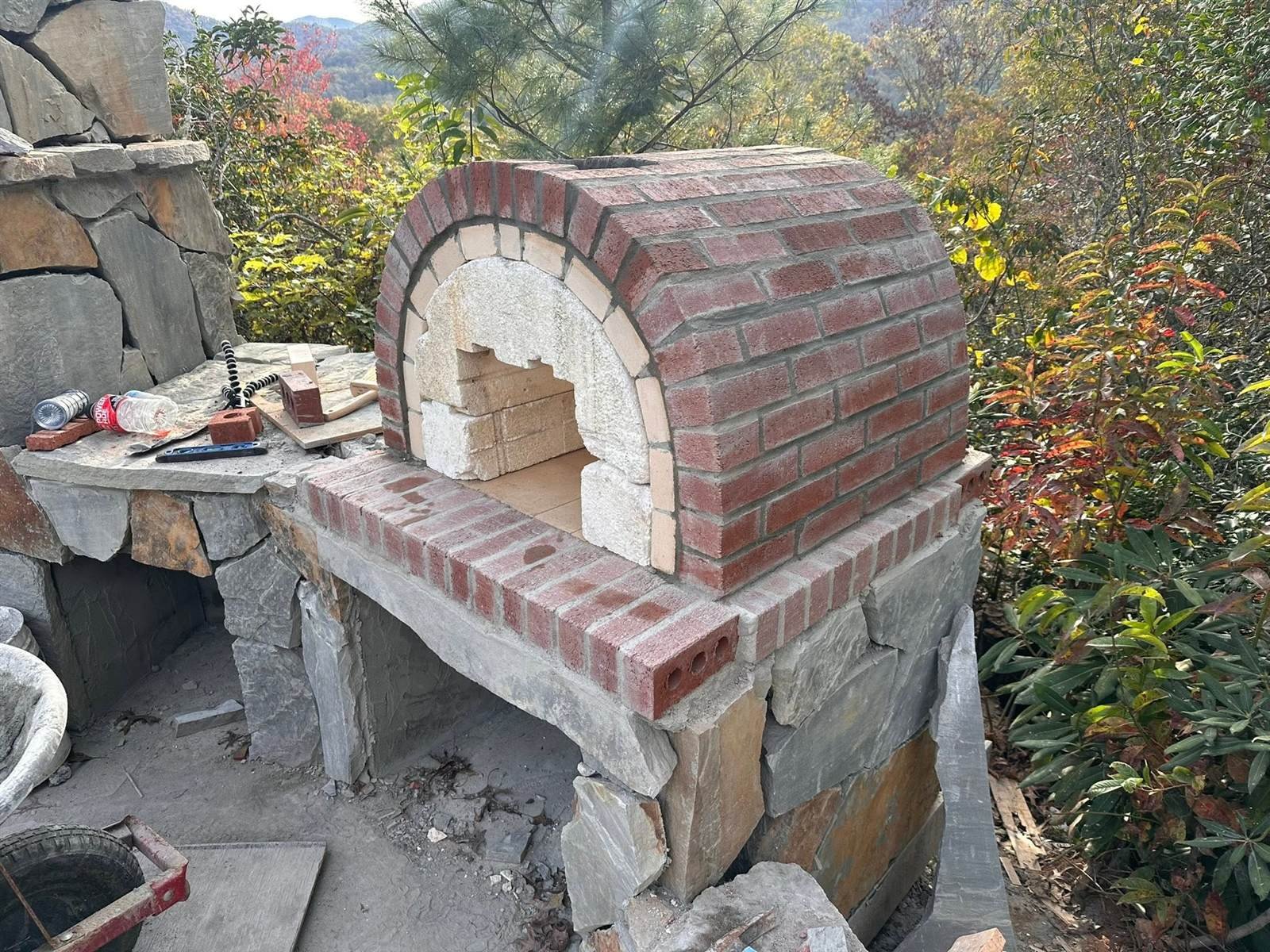 Custom pool-side waterfall and stone water feature built by Luxury Landscapes